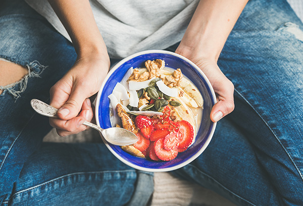 A woman eats a healthy meal.
