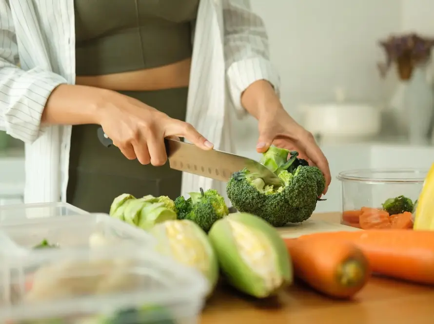 A woman prepares a nutritious meal for addiction recovery.