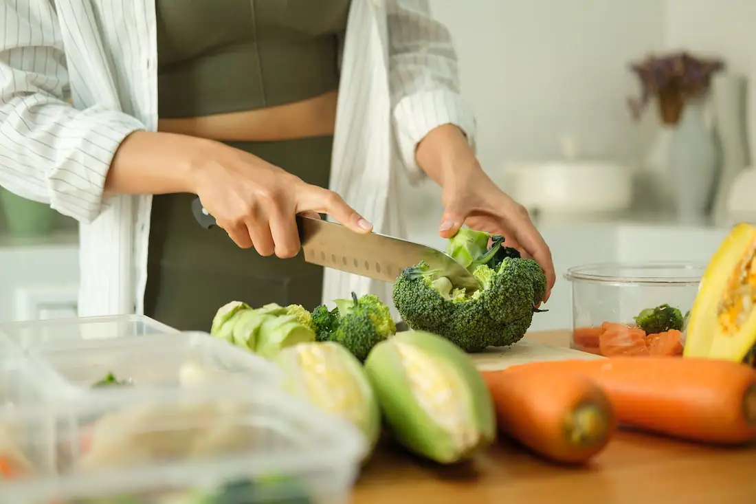 A woman prepares a nutritious meal for addiction recovery.