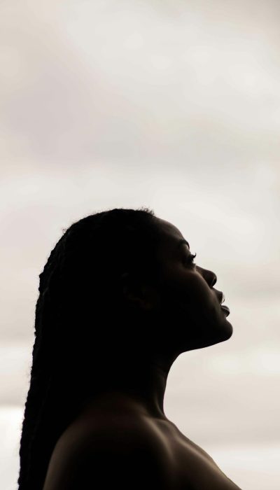 A woman looks at the sky.